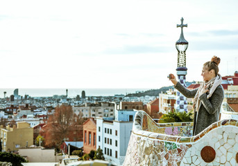 Fototapeta premium traveller woman in Barcelona taking photo with digital camera