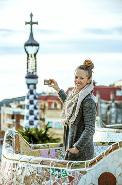 traveller woman at Guell Park taking photo with digital camera