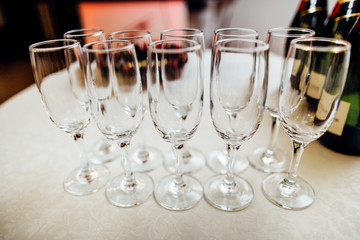 Elegant glasses with champagne standing in a white  table