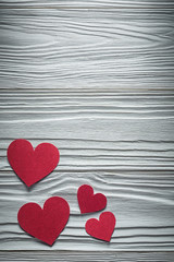 Collection of red paper hearts on wooden board Valentine cards