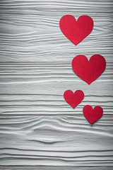 Composition of red hearts on wooden board Valentine cards