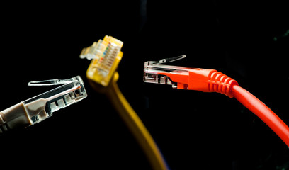 Red, yellow, gray color connectors communicate for internet on black background