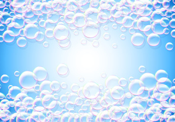 Soap bubbles abstract blue background with rainbow colored airy foam