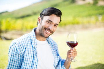 Portrait of smiling man holding red wine