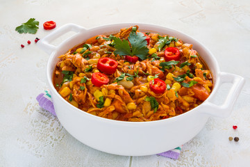 Hearty and healthy Southwest chicken and beans stew  in a white casserole on the table.