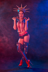 Young woman in stage costume of striptease dancer posing