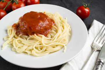 Spaghetti pasta with meatballs, tomato sauce. on dark background with copy space