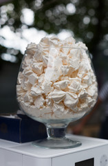 Meringue cookies in glass jar on bar for sale