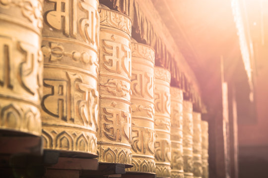 Background of prayer wheel in Buddhist temple in tibet with lens flare