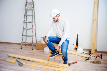 Builder with yellow tape measure