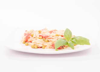 Risotto with tomato and pea on a white background