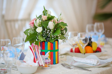 Wedding decoration table with flowers and raindows