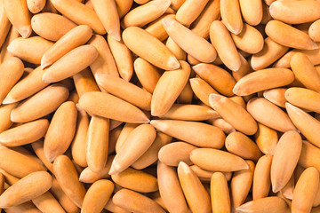 food background of pine nuts, top view