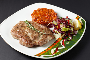 Pork steak with beans. Mexican food. Mexican cuisine.