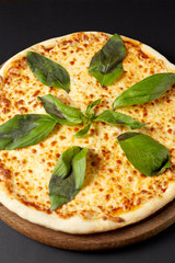 Hot pizza Margarita on a rustic wooden table.