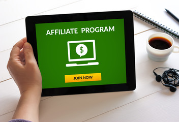 Hand holding digital tablet computer with affiliate program concept on screen. All screen content is designed by me