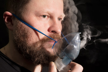 Man breathing through nebulizer mask