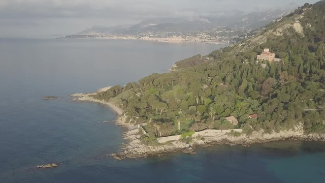 Flight over the mediterranean coastline on the border Italy France. Capo Mortola, Grimaldi (Ventimiglia), Italy, Europe. Aerial panoramic view 4K, UHD native log movie.