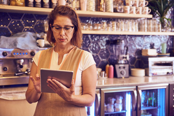 Coffee shop manager checking her supplies