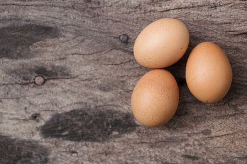 eggs on wood table background with space for text.
