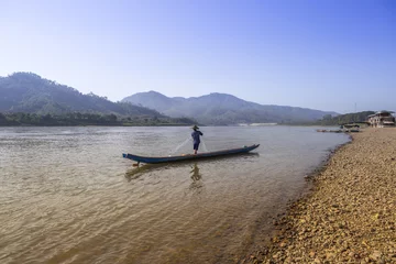 Foto op Canvas Man standing on fishing boat on river in Thailand © sirirak