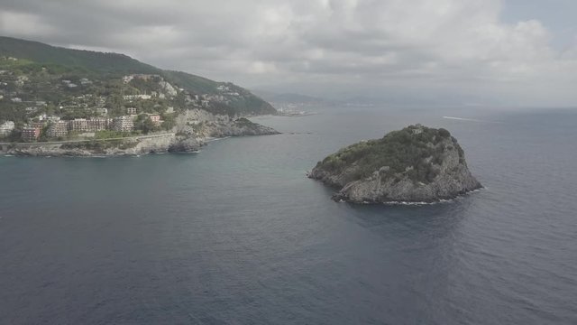 Flight over Bergeggi Island at sunrise, Spotorno, Liguria, Italy, Europe. Aerial panoramic view 4K, UHD native log movie.