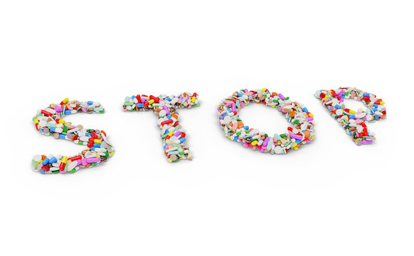 Medicine pills and capsules forming the word STOP