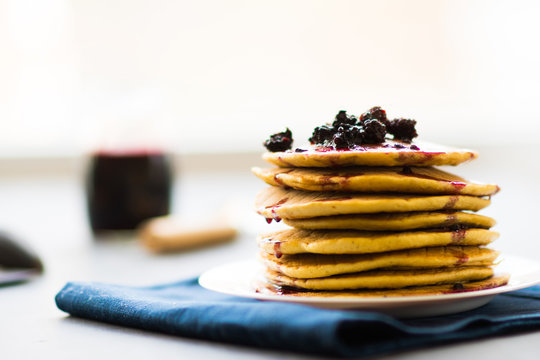 golden pancakes Delicious with  blackberries and blackberry jam.