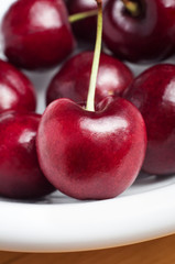 Red Cherries with Stems on White Plate