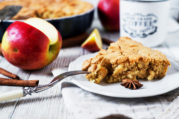 Homemade cake, apple pie with apples from a biscuit dough with cinnamon and black tea on a white...