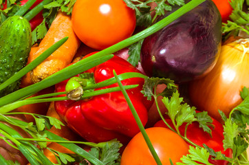 Colorful vegetables on wooden table background. Cooking preparation background. Tomato, pepper, cucumber and over vegetables on the kitchen desk. Close up view.