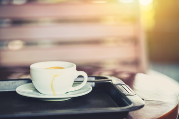 white drink coffee cup in the morning day at the cafe on wood table vintage color tone