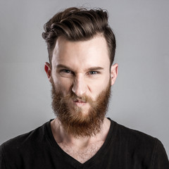 Obraz premium Very angry young man isolated on gray background