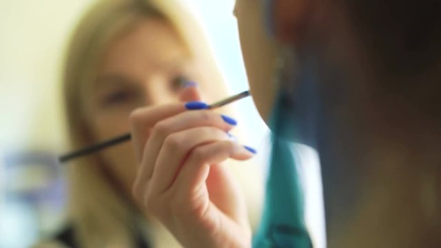 Make-up artist making bodyart of peahen for carnival and halloween for girl 4K