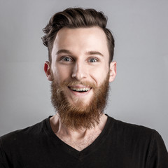 Obraz premium Exited young man isolated on gray background