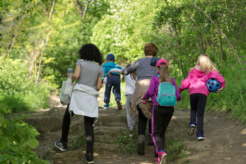 Mothers with children on the walk in forest, walk through forest in spring for your health
