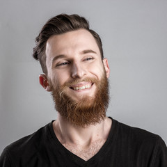 Obraz premium Joyful, happy young man isolated on gray backround