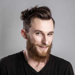 Shy young man isolated on gray backround