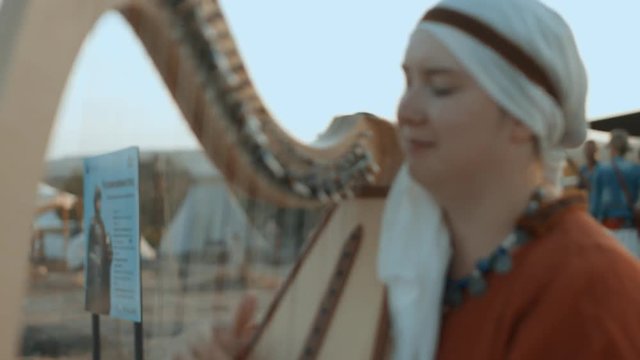 Medieval woman playing the harp