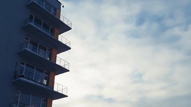 Office building with balconies on a background of blue sky