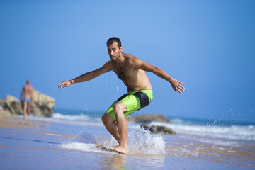 Skimboarder in beach