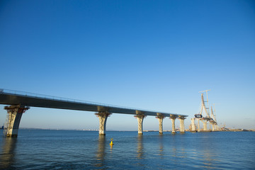 Fototapeta na wymiar Construction of big guyed bridge in Cádiz over the sea
