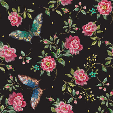 Embroidery trend floral seamless pattern with roses and exotic butterflies. Vector traditional folk flowers decor on black background for clothing design.