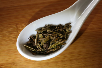 Fototapeta na wymiar porcelain spoon with green tea