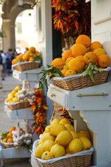 fresh crop of oranges and lemon in wooden boxes on a street market  - 146147040