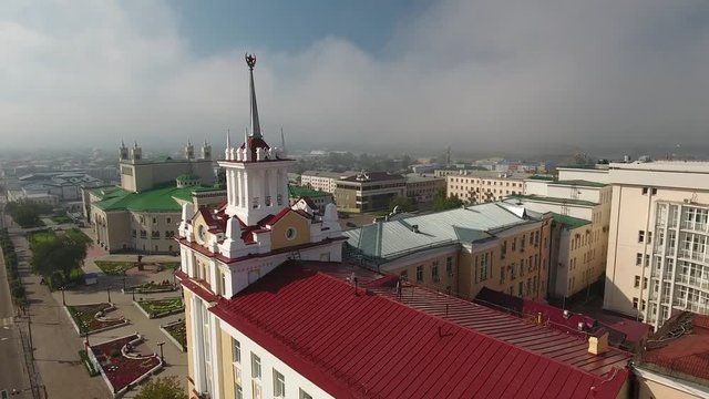 Zabaikalles committee and broadcasting building Soviet Square and Teatralnaya. State Academic Opera Ballet Theater Russia Ulan-Ude Siberia Summer blue sky Approach to theater from square Flight Drone 