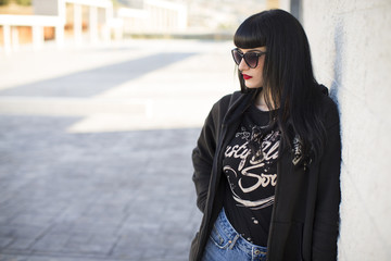 Portrait of a young beautiful woman in a urban background wearing black clothing