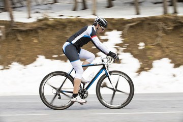 Cyclist man riding mountain bike on a mountain road.