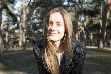 Young model looking at camera and smiling. Outdoor. Autumn. Headshot.