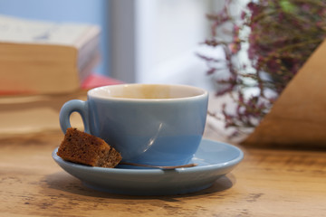 Cup of Coffee and Cake with a Book and some Flowers